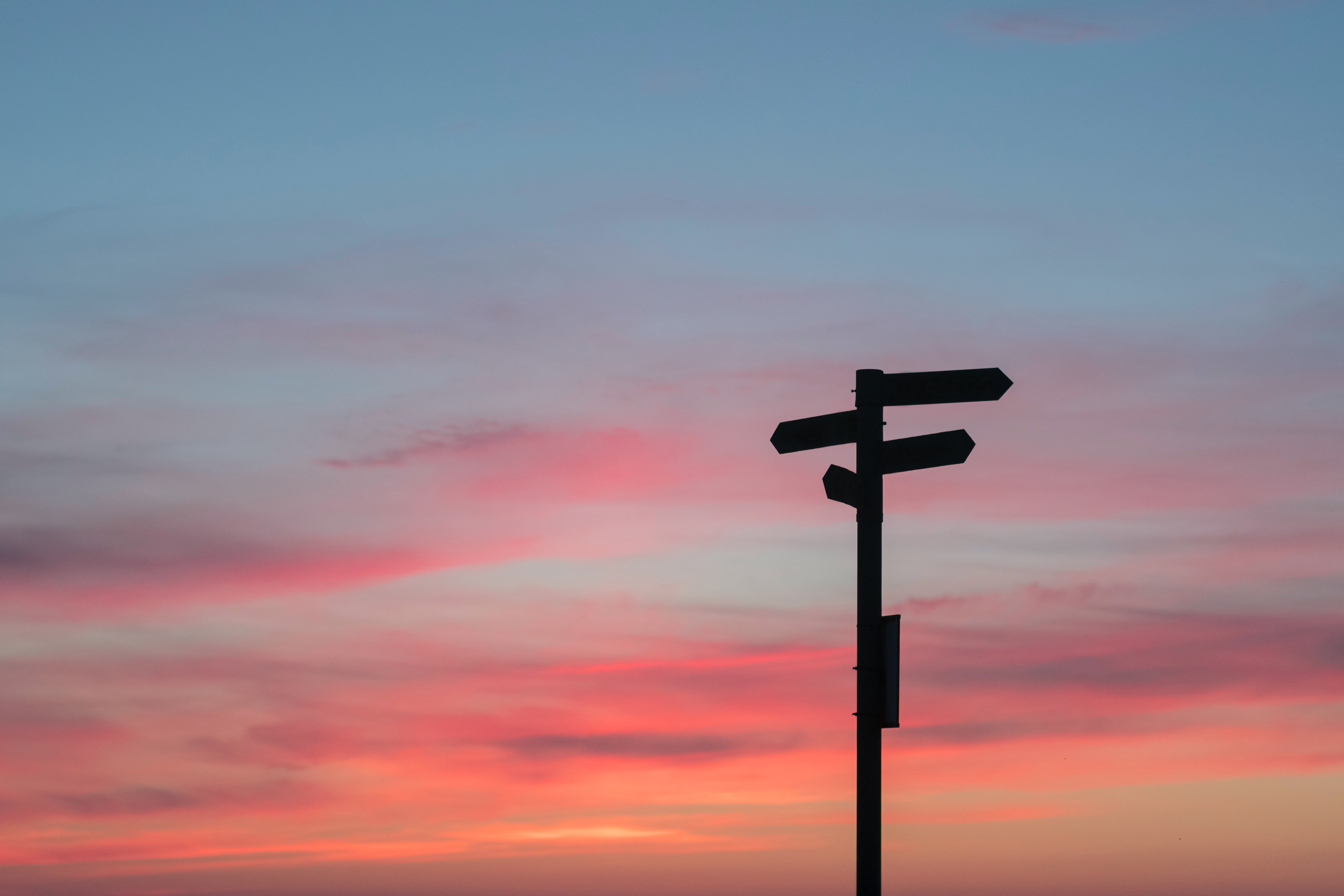 signpost in sunset sky