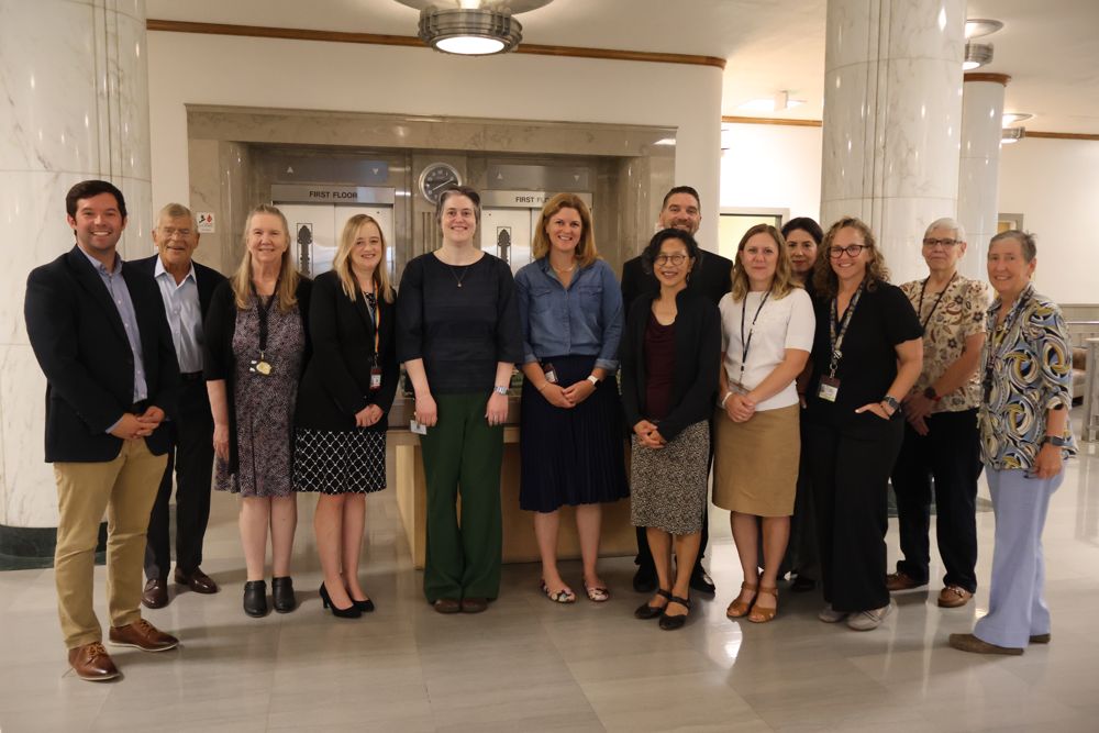 ELP group in front of an elevator and marble columns