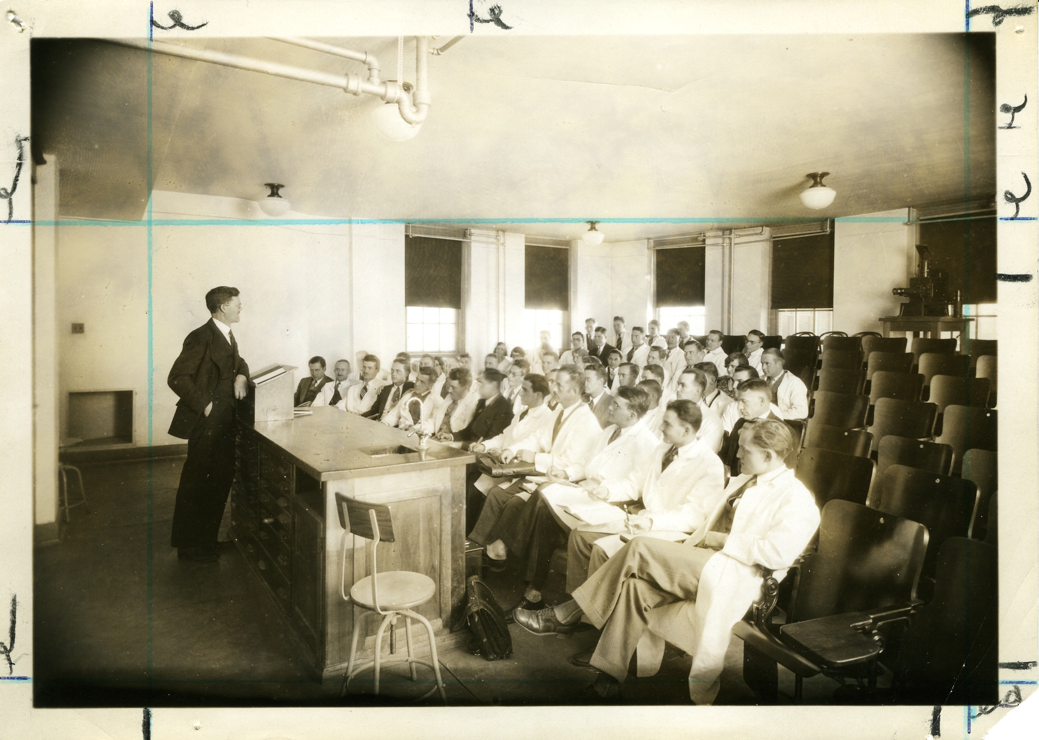 A professor teaches graduate students in a 1950s Anschutz classroom.