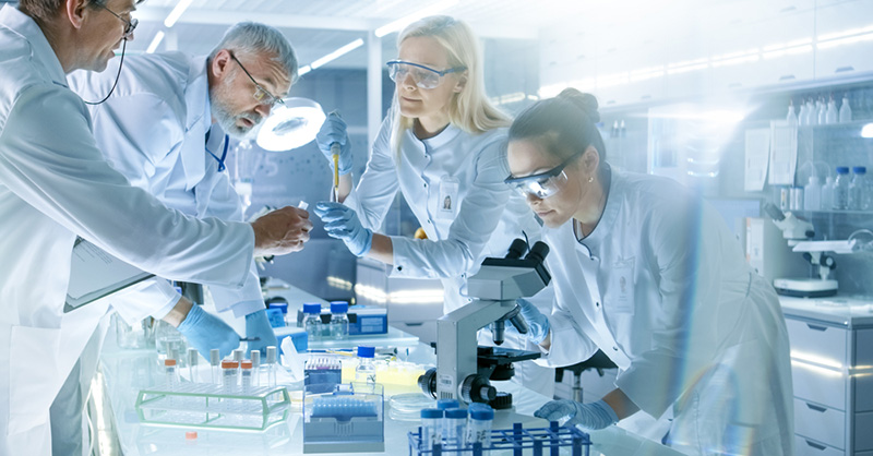 scientists around lab bench