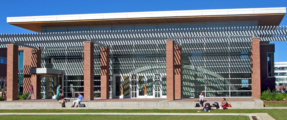 People sitting outside of a building on a sunny day