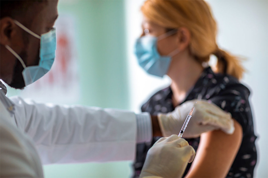 woman receiving vaccine woman receiving vaccine