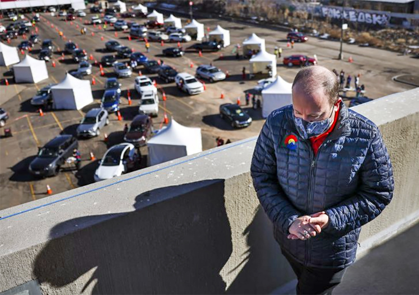 Gov. Jared Polis visits a mass COVID-19 vaccination event on Jan. 30 in Denver