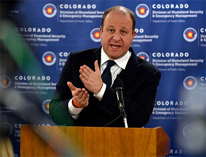 Governor Polis at podium