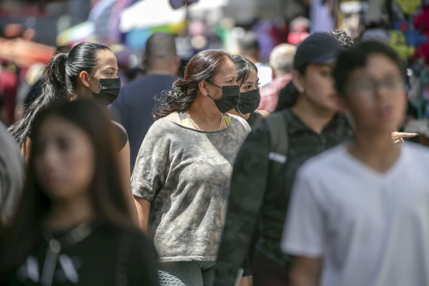 Shoppers with and without masks stroll in L.A.'s Santee Alley in July