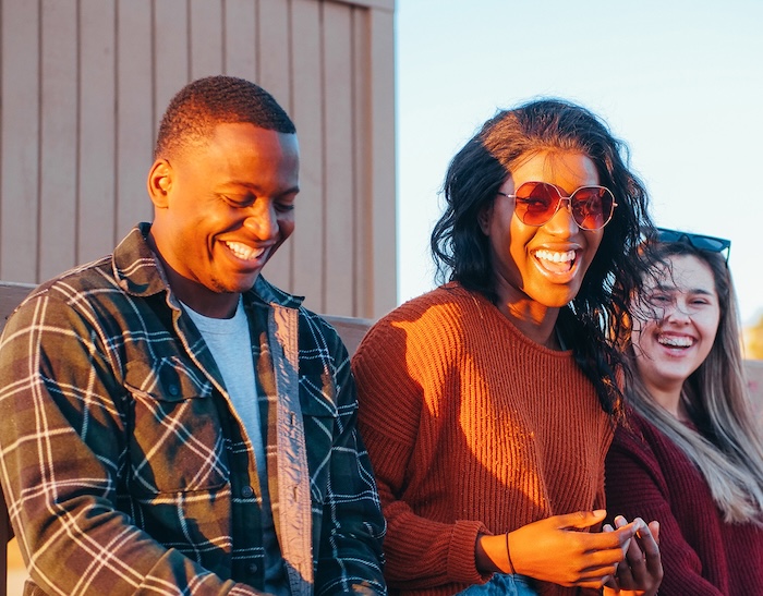 Three people sitting in grandstands