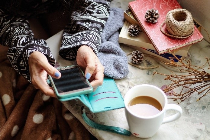 Coffee mug and Phone in Hands