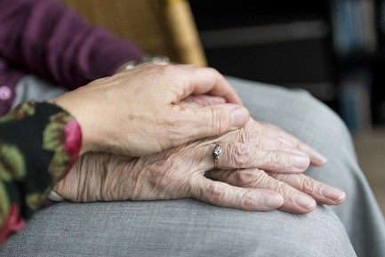 Elderly hands embracing