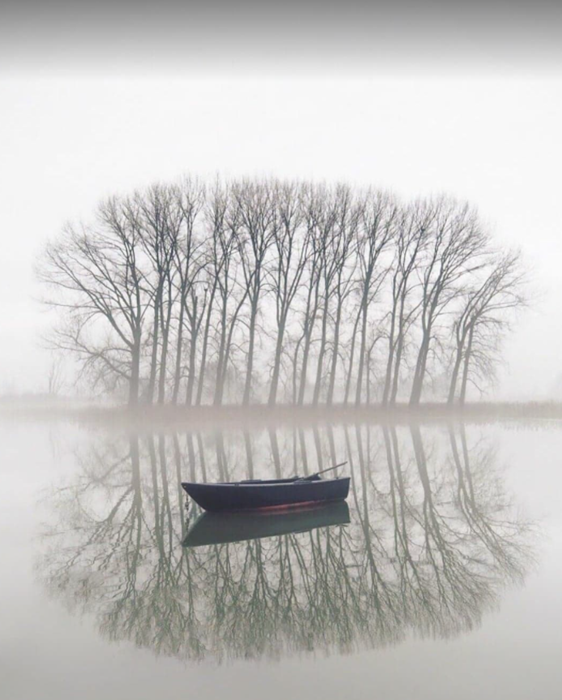empty boat on reflective lake empty boat on reflective lake