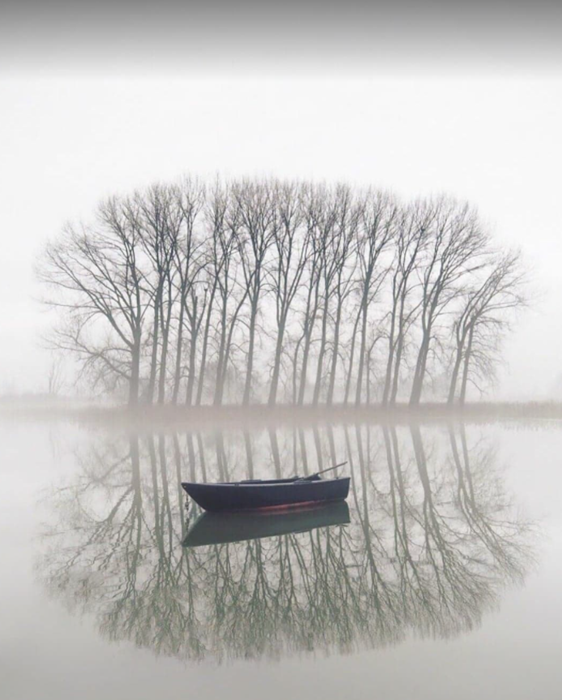 empty boat on reflective lake