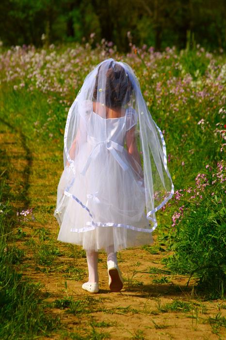 girl walking with communion dress