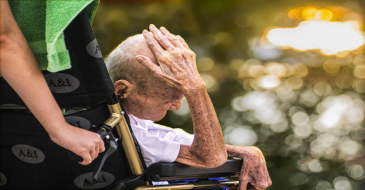 Nurse pushing elderly patient