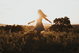 Woman dancing in field