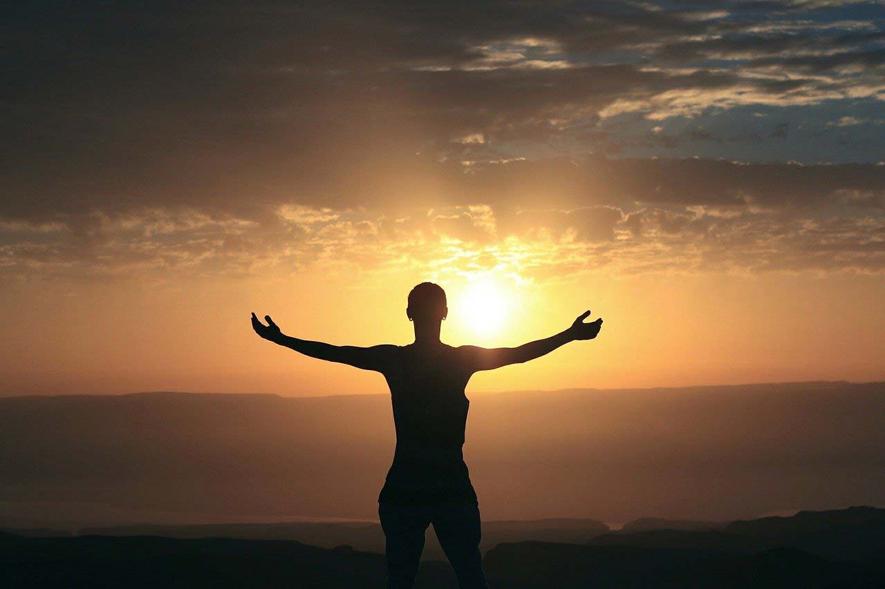 silhouette of a person in front of the sun