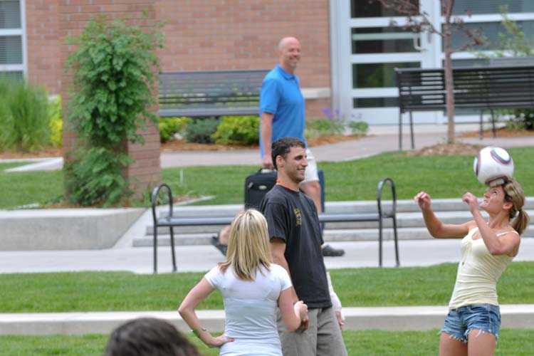 A person bouncing a soccer ball off their head