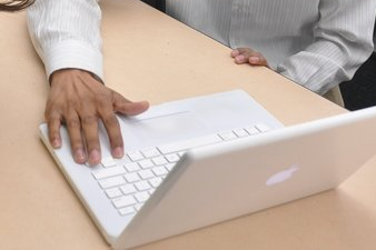 Student typing on a laptop