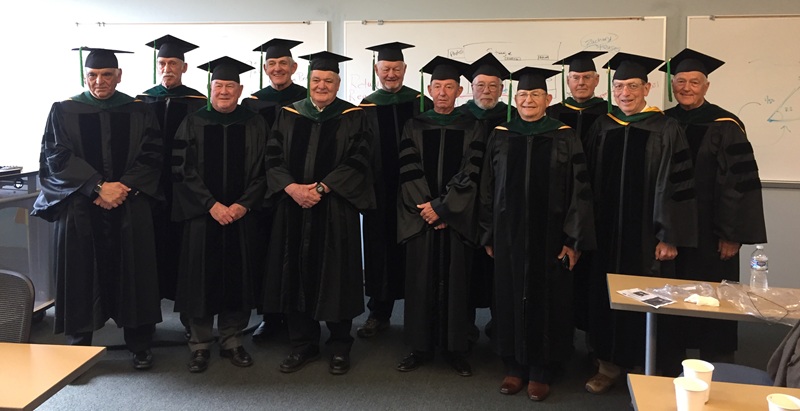 The Class of 1967 pose for a group group photo wearing their doctoral gowns during a recent gathering.