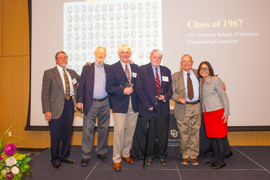 Shanta Zimmer, MD poses on stage with members of the Class of 1967 Fundraising Committee.