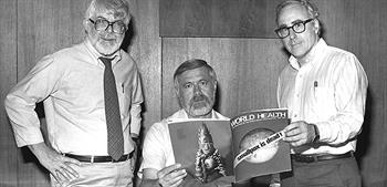 Directors looking at magazine of world health