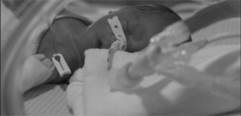 newborn with oxygen tube in nose