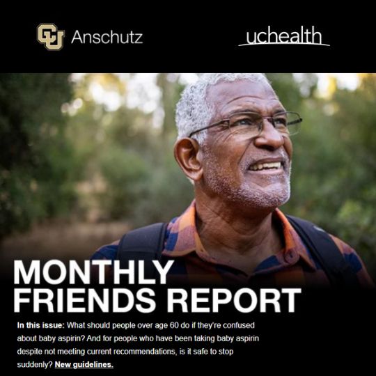 Monthly Friends Report: An older Black man with gray hair and glasses smiling outdoors while wearing a backpack and an orange-and-blue plaid shirt.