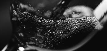 black and white photo of red wine in glass