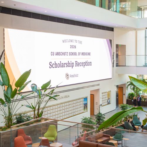 The CU Anschutz Health Sciences Building jumbotron displays a welcome sign for the 2026 School of Medicine Scholarship Reception.
