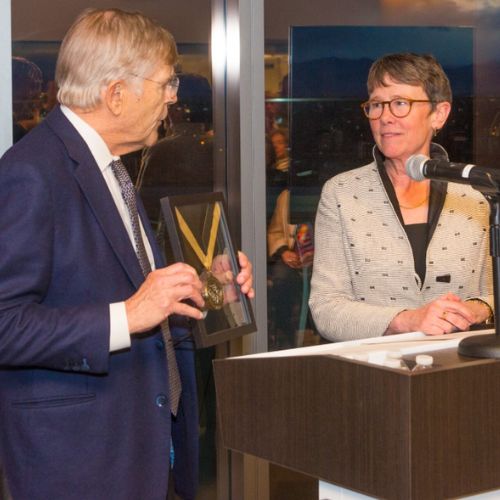 Don Elliman presents Dr. Reusch with an honorary medallion.