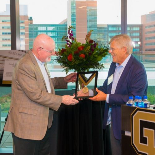 Medal presentation during the Penny S. Burke Endowed Chair in Behavioral Neurology celebration.