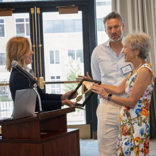 Cathy Bradley presents honorary medallions to members of the Berman family during the endowed chair celebration..