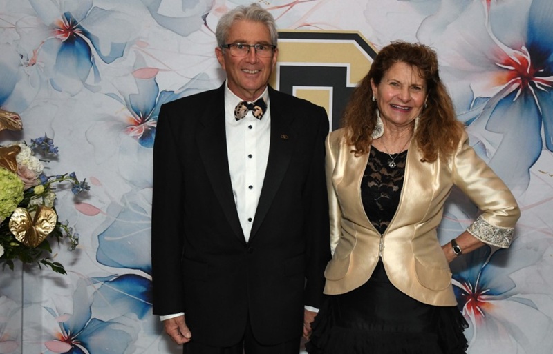 Joanne Posner-Mayer and her partner dressed up in CU black and gold evening wear for a Heritage Society event.