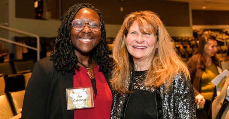 Mak Callender and Joanne Posner-Mayer pose for a picture together at a CU celebration event.