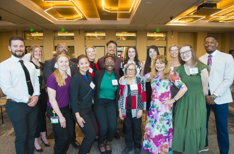 Joanne Posner-Mayer in a group photo with other donors and students at a scholarship celebration event.