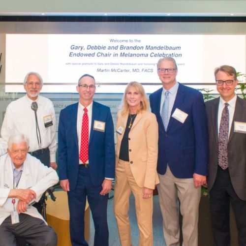 Gary, Debbie Mandelbaum pose with faculty during the Endowed Chair in Melanoma Research Celebration.