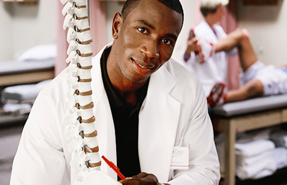 Doctor examining skeletal spine