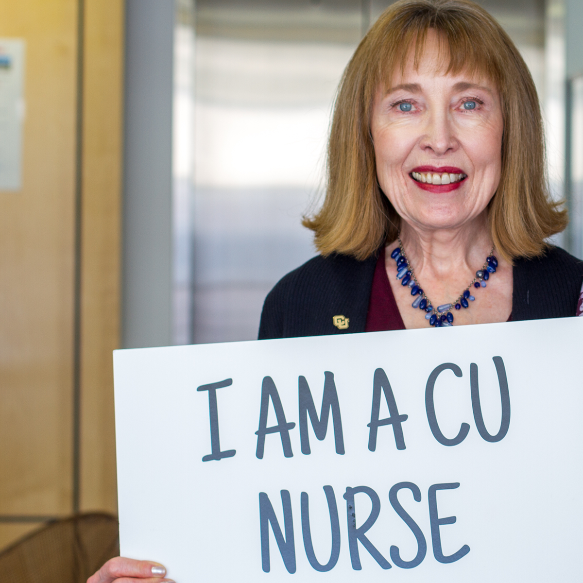 Women holding I am a CU Nurse sign