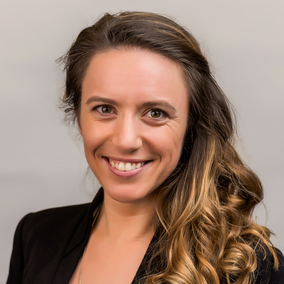 Caitlin K. Robinson, medical scholar. She is wearing a black blazer and smiling at the camera.