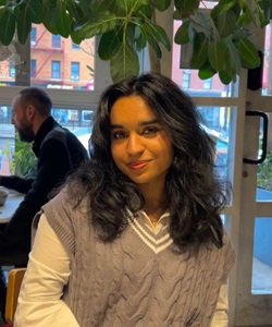 Fatima Salman sitting in a coffee shop.