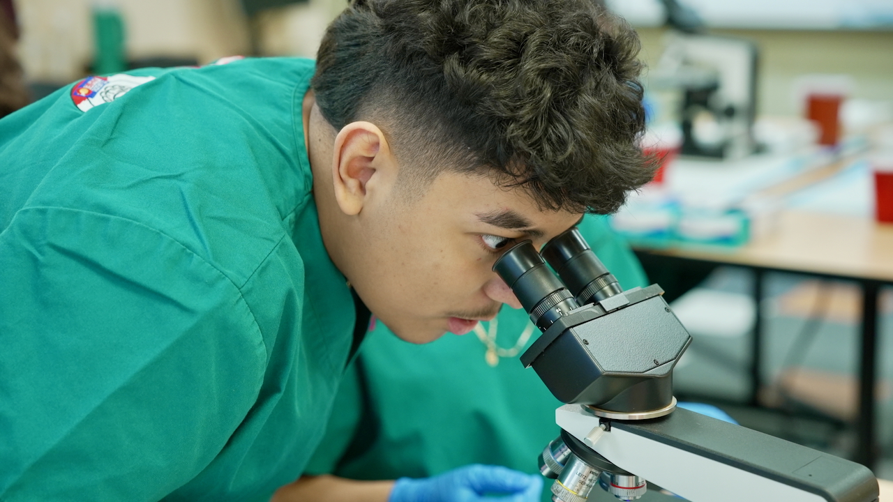 CADAVERS student at microscope