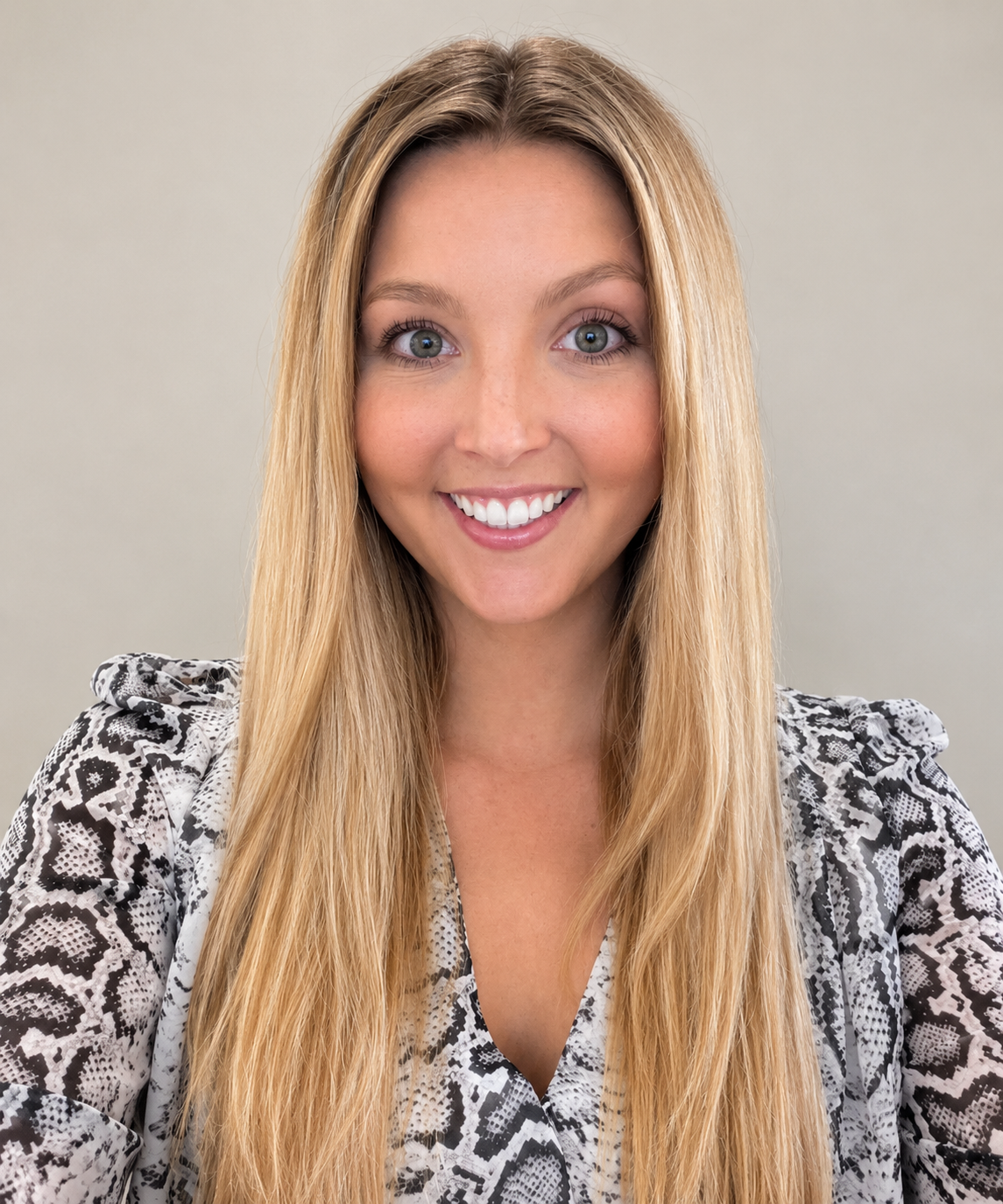 Picture of Camryn, smiling in front of a white wall background