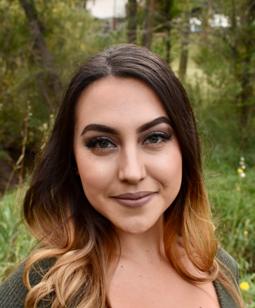 Photo of Alisya Rodriguez with a forest behind her