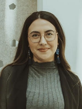 A photo of Alisya Rodriguez in front of a gray background