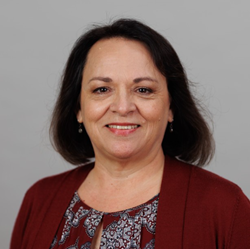 Professional headshot of Dr. Deborah Parra-Medina, who is smiling at the camera