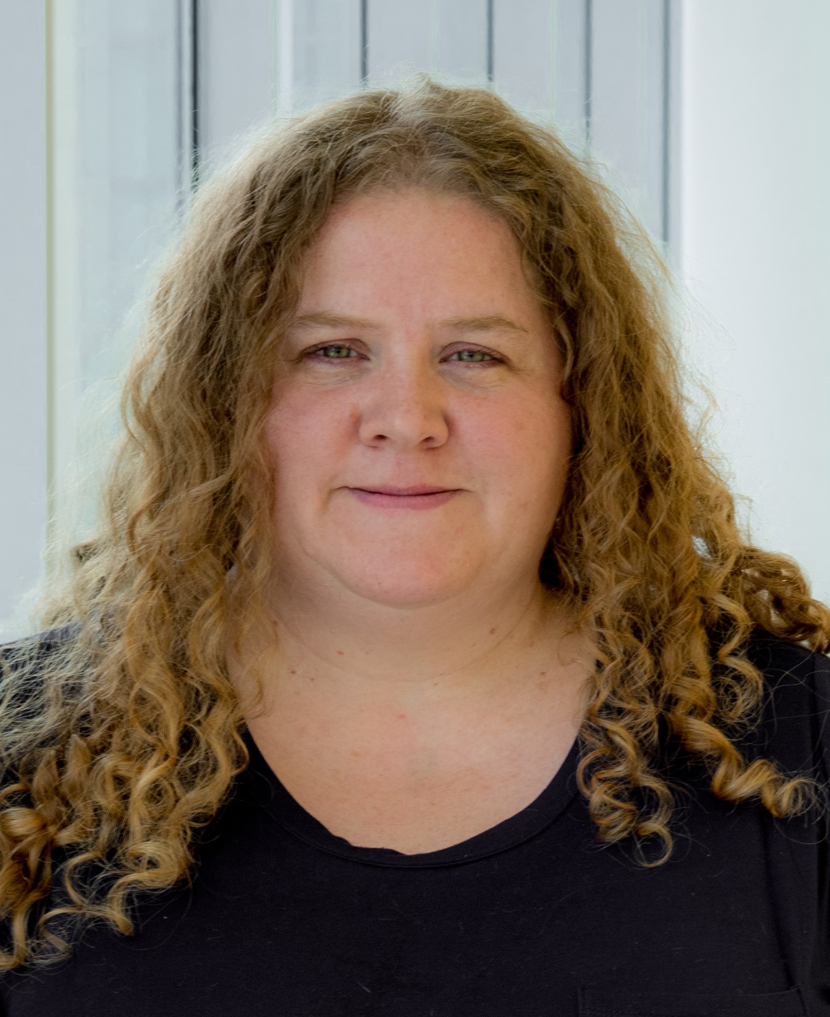 Picture of Dionisia de la Cerda smiling in front of a window