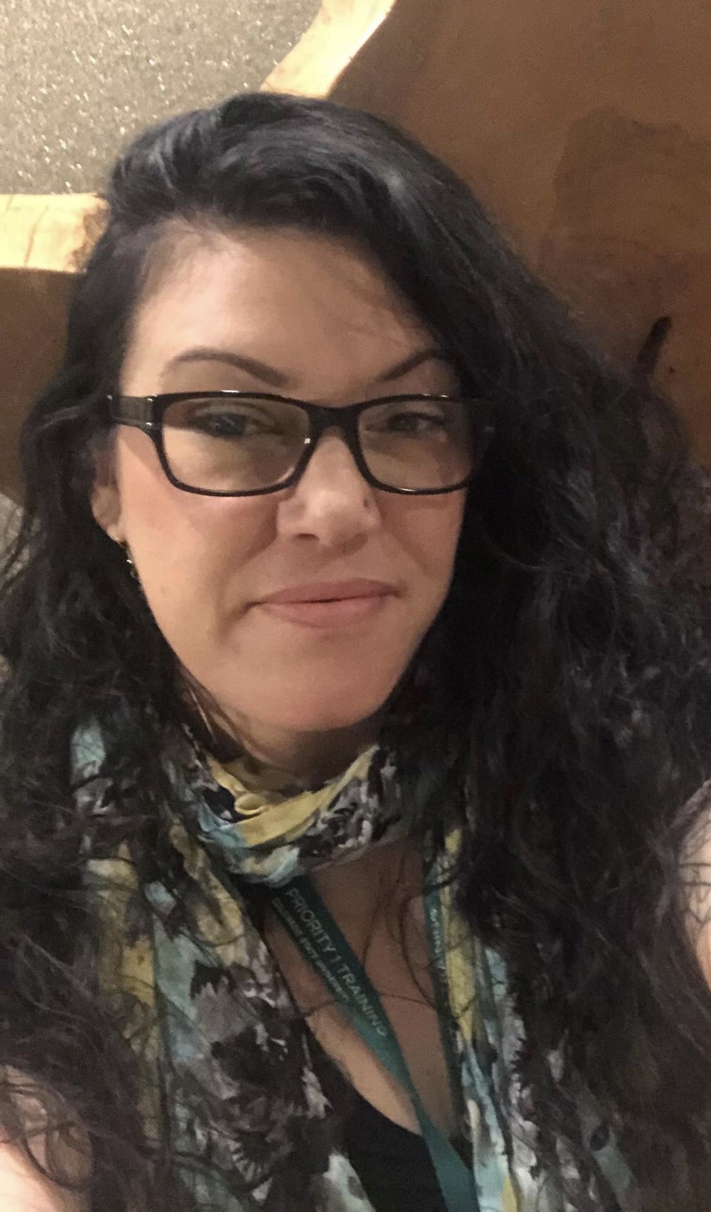 Photo of Sam Dancis smiling in front of a gray background