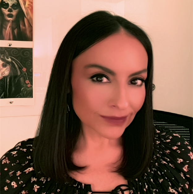 Montelle - resized Headshot of Montelle Tamez; she smiles and wears a black top with a floral pattern