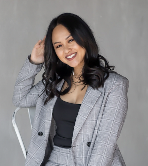 Sothary Chea smiles in a gray suit with a black top