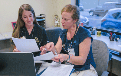 Anschutz students looking at information