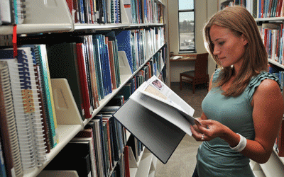 An Anschutz student flipping pages of a book