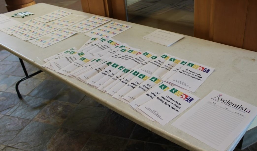 Table covered in flyers for Spring Symposium